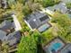 Aerial shot showcasing the home's pool and solar panels amidst beautiful greenery and surrounding houses at 1682 Wingspan Way, Winter Springs, FL 32708
