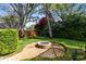Beautiful backyard with a circular brick fire pit and swing set, perfect for relaxing and entertaining at 1682 Wingspan Way, Winter Springs, FL 32708