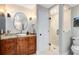 Bathroom boasts granite counters, vessel sink, modern fixtures, and walk-in shower with seamless glass doors at 1682 Wingspan Way, Winter Springs, FL 32708