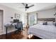Bedroom features a comfortable bed with a unique headboard, a desk area, and wood floors creating a warm space at 1682 Wingspan Way, Winter Springs, FL 32708