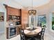 Cozy breakfast nook with custom cabinetry, wine fridge and a nice view of the pool at 1682 Wingspan Way, Winter Springs, FL 32708