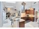 Open-concept kitchen featuring a stunning marble island, stainless steel appliances, and custom cabinetry at 1682 Wingspan Way, Winter Springs, FL 32708