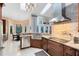 Gorgeous kitchen boasting granite countertops, stainless steel appliances, and a stylish range hood at 1682 Wingspan Way, Winter Springs, FL 32708