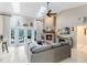 Open living room with stone fireplace, ceiling fan and view of pool area at 1682 Wingspan Way, Winter Springs, FL 32708
