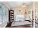 Charming living room featuring hardwood floors, a white piano and large windows for natural light at 1682 Wingspan Way, Winter Springs, FL 32708