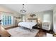 Inviting primary bedroom featuring a wooden bed frame, natural light, and neutral color scheme at 1682 Wingspan Way, Winter Springs, FL 32708