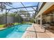 Screened-in pool with waterfall feature is adjacent to patio and dining area offering the ultimate outdoor experience at 1682 Wingspan Way, Winter Springs, FL 32708
