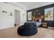 Modern bedroom featuring sleek black accent wall, wood headboard, and floating shelves at 16936 Champlain St, Clermont, FL 34714