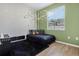 This bedroom has stylish wood floors, a charming wall decal, and a comfy bed at 16936 Champlain St, Clermont, FL 34714