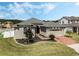 Beautiful single-Gathering home with a well-kept lawn, brick-paved driveway, and attached garage at 16936 Champlain St, Clermont, FL 34714