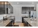 Modern kitchen features granite countertops, stainless appliances, and dark wood cabinets at 16936 Champlain St, Clermont, FL 34714