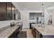 A gourmet kitchen featuring granite countertops, stainless appliances and dark wood cabinets at 16936 Champlain St, Clermont, FL 34714