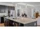 Open floor plan kitchen features granite counters, stainless steel appliances, and a large island for entertaining at 16936 Champlain St, Clermont, FL 34714