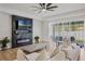 Bright and modern living room featuring a fireplace and sliding glass doors to the backyard at 16936 Champlain St, Clermont, FL 34714