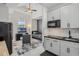Open-concept space with a modern kitchen and cozy bedroom area, blending style and functionality at 16936 Champlain St, Clermont, FL 34714