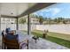 Covered outdoor patio area with stylish seating, a fire pit, and a view of the backyard at 16936 Champlain St, Clermont, FL 34714