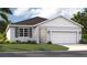 Charming single-Gathering home with a two-car garage, well-maintained lawn, and beautiful landscaping at 1712 Blue Lagoon Cir, Mascotte, FL 34753