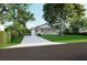 Inviting one-story home with a beautifully landscaped front yard and a long driveway at 1727 Barrow St, Deltona, FL 32725