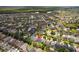 Picturesque aerial view of a community featuring well-kept homes surrounded by mature trees at 1825 Saffron Plum Ln, Orlando, FL 32828