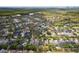Sprawling neighborhood aerial view with a lake, green spaces, and neat residential streets at 1825 Saffron Plum Ln, Orlando, FL 32828