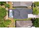 Aerial view of a roof and screened in pool, surrounded by lush landscaping at 1825 Saffron Plum Ln, Orlando, FL 32828