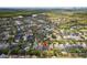 Sprawling neighborhood aerial view with a lake, green spaces, and neat residential streets at 1825 Saffron Plum Ln, Orlando, FL 32828
