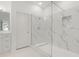 Bathroom featuring frameless glass shower with marble-like tiling and built-in shelf at 1825 Saffron Plum Ln, Orlando, FL 32828