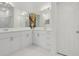 Bright bathroom features double sink vanity with a decorative mirror and cabinet at 1825 Saffron Plum Ln, Orlando, FL 32828