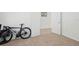Neutral bedroom with carpet, white doors, and bicycle at 1825 Saffron Plum Ln, Orlando, FL 32828