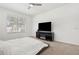 Bright bedroom featuring a sleek entertainment center with a modern electric fireplace at 1825 Saffron Plum Ln, Orlando, FL 32828
