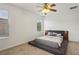 Bright bedroom features neutral paint, plush carpeting, and natural light from the windows at 1825 Saffron Plum Ln, Orlando, FL 32828