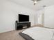 Brightly lit bedroom boasts a ceiling fan and sleek entertainment center at 1825 Saffron Plum Ln, Orlando, FL 32828