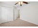 Bedroom with ceiling fan, and double closet doors at 1825 Saffron Plum Ln, Orlando, FL 32828