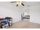 Bedroom view leads to main bedroom with ceiling fan and platform bed at 1825 Saffron Plum Ln, Orlando, FL 32828