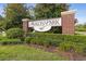 A welcoming Avalon Park community sign with brick pillars surrounded by manicured landscaping at 1825 Saffron Plum Ln, Orlando, FL 32828