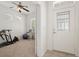 Entryway view leading into a home gym/office with a ceiling fan and natural light at 1825 Saffron Plum Ln, Orlando, FL 32828