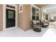 Charming front porch area with rocking chairs, a stylish entrance door, and manicured landscaping at 1825 Saffron Plum Ln, Orlando, FL 32828