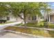 Charming home boasts a front porch and well-manicured lawn at 1825 Saffron Plum Ln, Orlando, FL 32828