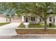 Charming home boasts a front porch and well-manicured lawn at 1825 Saffron Plum Ln, Orlando, FL 32828