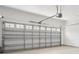 Spacious two car garage with white painted brick walls and a automatic garage door opener at 1825 Saffron Plum Ln, Orlando, FL 32828