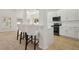 Bright kitchen with white cabinets, stainless steel appliances, and breakfast bar with seating at 1825 Saffron Plum Ln, Orlando, FL 32828