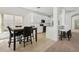 Modern kitchen with white cabinetry, granite countertops, and breakfast bar at 1825 Saffron Plum Ln, Orlando, FL 32828