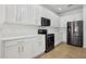 Well-lit kitchen featuring stainless steel appliances, white cabinets with gold hardware, and tile floors at 1825 Saffron Plum Ln, Orlando, FL 32828