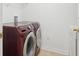 Maroon front-loading Samsung washer and dryer set in laundry room at 1825 Saffron Plum Ln, Orlando, FL 32828
