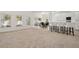 Expansive living area with windows, a dining table, kitchen bar, and plush carpeting at 1825 Saffron Plum Ln, Orlando, FL 32828
