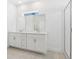 Modern bathroom featuring a double vanity and a glass-enclosed shower at 1912 Archer Dr, Minneola, FL 34715