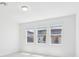 Sun-filled bedroom with three windows and white walls at 1912 Archer Dr, Minneola, FL 34715