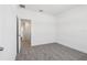 Neutral carpeted bedroom featuring an open door, painted in neutral colors at 1912 Archer Dr, Minneola, FL 34715