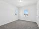Bright, carpeted bedroom with two windows allowing ample natural light at 1912 Archer Dr, Minneola, FL 34715