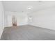 Light-filled bedroom with soft carpeting, white walls, and interior door at 1912 Archer Dr, Minneola, FL 34715